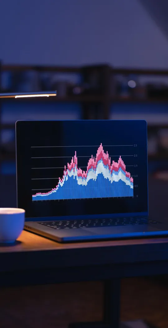 laptop with a cup of coffee late in the evening